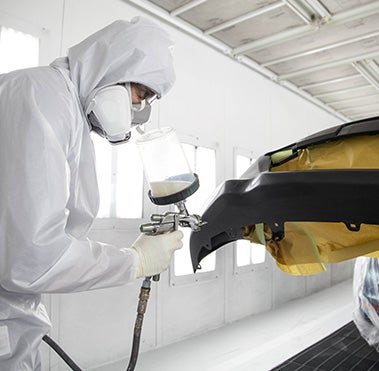 Collision Center Technician Painting a Vehicle | Seeger Toyota of St. Robert in St Robert MO